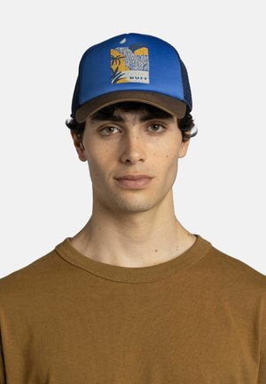 Young man wearing a blue and brown cap with a nature design and "BUFF" text, and a brown crew-neck shirt, facing forward.