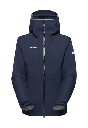 Giacca impermeabile blu navy con cappuccio, zip frontale, polsini con velcro e logo bianco "Mammut" sul petto e sulla toppa sul braccio.