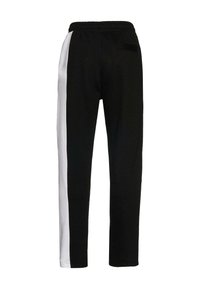 Black athletic pants with a white side stripe, elastic waistband, and single back pocket. Soft fabric, tapered fit, and smooth texture.