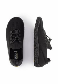 Black athletic shoes with a woven upper, elastic laces, and textured rubber sole. Notable yellow accents on heel and sole pattern.