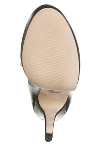 Černá kožená podpatková bota se hladkým, béžovým gumovým grip povrchem a vertikálními drážkami pro trakci. Elegantní tvarovaný design podpatku.