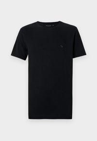 T-shirt en coton noir à manches courtes, col rond, avec un petit logo discret de couleur assortie sur la partie gauche de la poitrine.