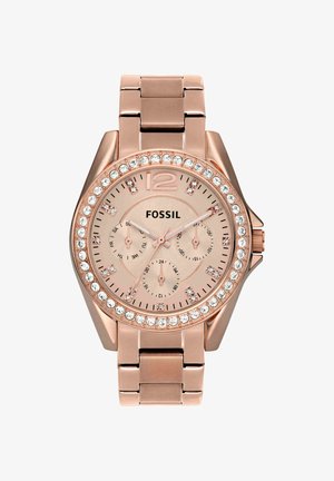 Montre-bracelet Fossil en or rose avec lunette sertie de cristaux, trois sous-cadrans et bracelet à maillons métalliques, affichant l’heure 10h08.