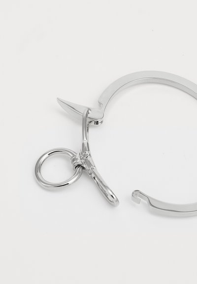 Silver metal tool featuring a sharp blade, a circular handle, and a hook design. Smooth surface with a polished finish, compact shape.