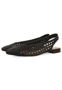 Des ballerines à talon slingback tissées noires avec un bout pointu, des côtés ouverts avec des découpes hexagonales et un petit talon. Doublure intérieure lisse.