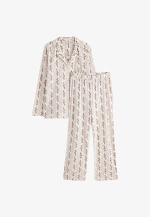 Puuvillainen pyjama-asusetti, jossa on valkoinen tausta, jossa on pystysuoria punaisia ja vihreitä kukkakaistaleita. Mukana on kauluksellinen nappipaita ja elastiset housut.