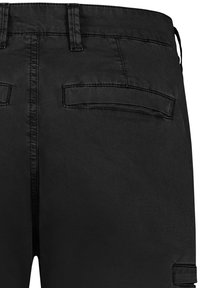 Black cargo pants featuring a smooth texture with two back pockets and a button closure at the waist. The fabric appears lightweight and durable.
