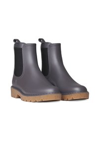 Botas Chelsea de goma grises con paneles laterales elásticos negros y suelas de goma texturizada color marrón. Cuenta con una lengüeta para facilitar su colocación.