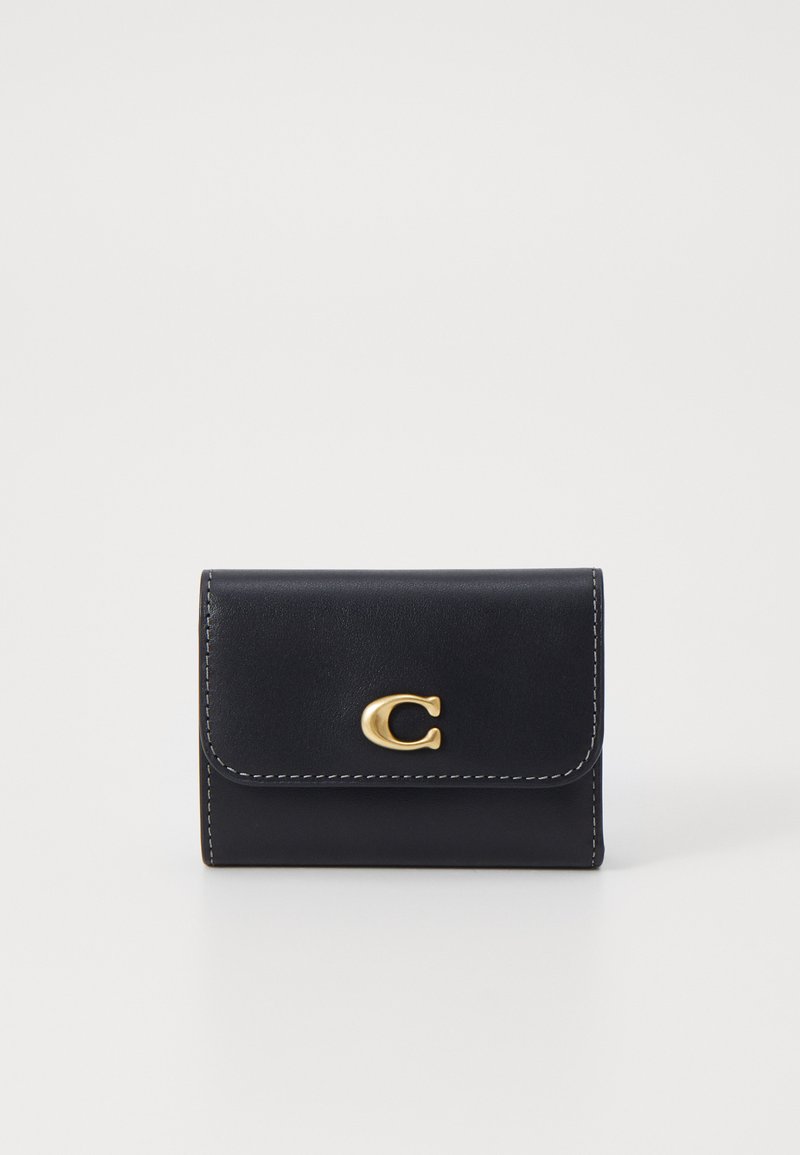 Black leather wallet featuring a gold logo accent, stitched detailing, and a fold-over flap design. Compact and rectangular shape.