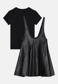Black leather camisole with a scooped neckline and flared design, layered over a plain black t-shirt with a crew neck.