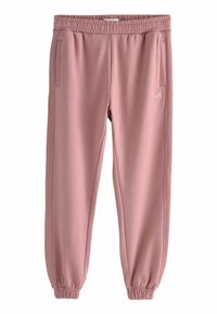 Roosa sportpants, millel on elastne vöökoht, kitsenevad mansetid ja küljetaskud. Valmistatud pehmest materjalist, millel on ees väike valge logo.