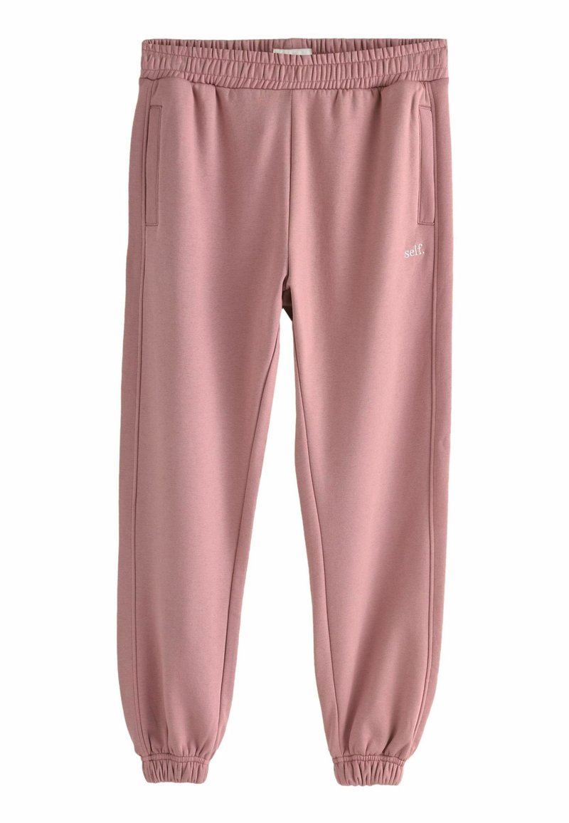 Roosa sportpants, millel on elastne vöökoht, kitsenevad mansetid ja küljetaskud. Valmistatud pehmest materjalist, millel on ees väike valge logo.