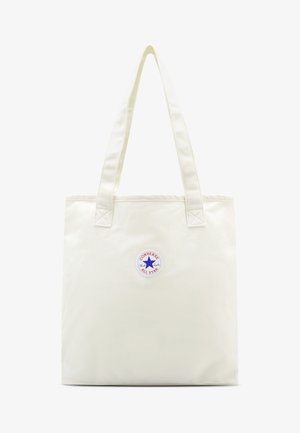 Platnena torba v smetano beli barvi z dvema naramnicama in okroglim logotipom v modri in rdeči barvi. Gladka tekstura z ojačanimi šivi.