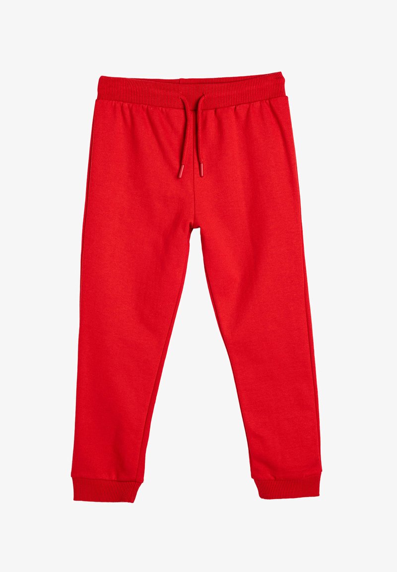Punaiset sweatpantsit, joissa on elastinen vyötärönauha ja nyöri. Taitokset nilkoissa. Silkkinen pinta ja tasainen väri kauttaaltaan.