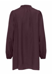 Μπλούζα με μακριά μανίκια σε μπορντό χρώμα, με βολάν στη λαιμόκοψη, πλισέ λεπτομέρειες στους ώμους και ελαστικά μανσέτα. Λεία υφή υφάσματος.
