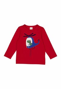 Červená košile s dlouhým rukávem, na které je modrá grafika vrtulníku se dinosaurem uvnitř. Vyrobeno z měkké bavlny s kulatým výstřihem.