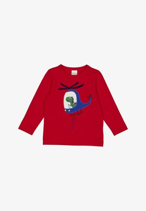 Maglietta rossa a maniche lunghe con una grafica di un elicottero blu con un dinosauro all'interno. Realizzata in morbido cotone e con scollatura rotonda.