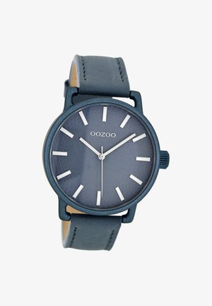Montre Oozoo ronde avec un cadran texturé bleu foncé, des index d'heure en argent et un bracelet en cuir assorti. Présente un design simple et minimaliste.
