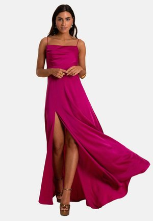 Fuchsia satin evening gown with a straight neckline, spaghetti straps, and a thigh-high slit. Features a flowing silhouette and smooth texture.