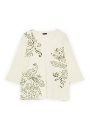 Langärmeliges Oberteil in Cremefarbe mit V-Ausschnitt und fein gearbeiteten dunklen Paisley-Blumenmustern auf der linken Schulter, unten rechts und am rechten Brustbereich.