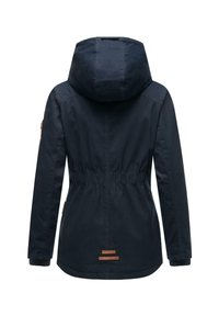 Navy blue waterproof jacket with a hood, elastic waist, long sleeves, and brown leather accents on the cuffs and hem.