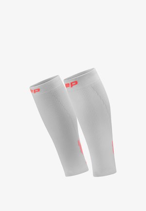 Pair of white compression calf sleeves with red branding accents, designed for athletic support and muscle stabilization.