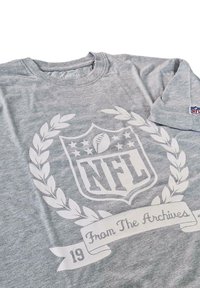 Gray cotton t-shirt featuring a large white NFL logo with laurel leaves and a ribbon that reads "From The Archives" in script.