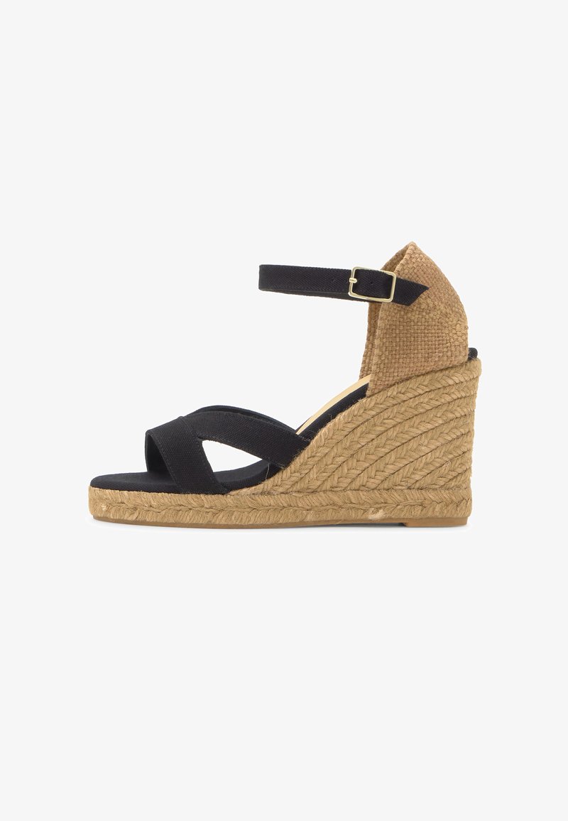 Sandale compensée en tissu noir avec bride à la cheville et semelle et talon en jute tissé, vue de côté sur fond blanc.