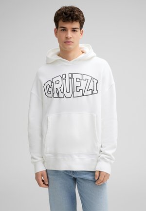 Witte katoenen hoodie met een grote zwarte "GRÜEZI" grafiek. Voorzien van een voorzak en een capuchon met koord. Casual ontwerp met een ontspannen pasvorm.
