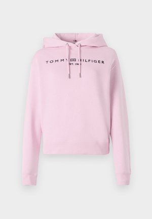 Ružová bavlnená mikina s cropped dizajnom. Obsahuje kapucňu so šnúrkou a na prednej strane je zobrazené logo s nápisom "TOMMY HILFIGER EST. 1985".