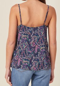 Navy patterned tank top with thin straps, featuring colorful swirling designs in pink, green, and white. Soft fabric with a loose fit.