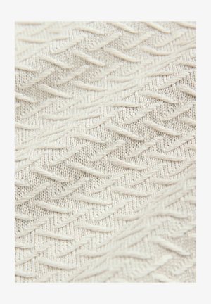 Texturierter Stoff in Cremeton mit Zickzackmuster und erhöhten Fäden für zusätzliche Tiefe und Dimension. Leicht und weich im Griff.