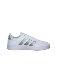 White athletic shoes with silver accents, featuring three diagonal stripes, a textured upper, and a rubber sole. Smooth finish throughout.