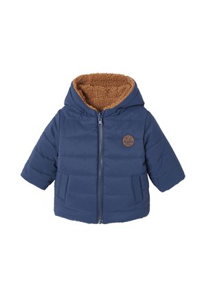Puffer jacket in navy blue with brown fleece lining, front zipper, and two side pockets. Features a logo patch on the chest.