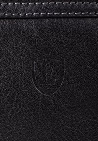 Black leather wallet with a textured surface, featuring stitched accents and an embossed shield logo.