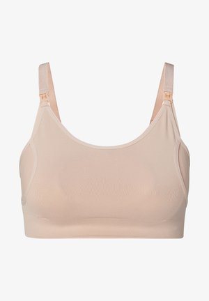 Lys beige trådløs bh lavet af glat stof. Har justerbare stropper og et sømløst design uden bøjler eller ekstra polstring.