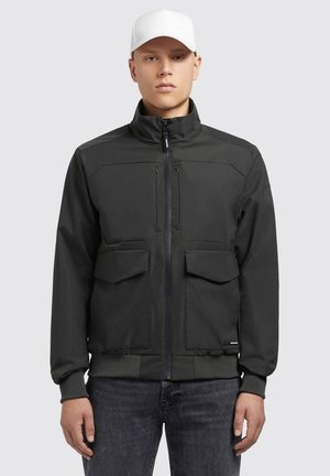 Black zipped jacket with two chest pockets and two front pockets. Features a high collar and ribbed cuffs. Smooth, matte fabric.