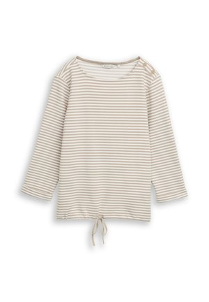 Beež ja valge horisontaalselt triibuline triiksärk pikkade varrukatega, ümmarguse kaelusega, õlaäärtega nööpide ja allääres seotava nööriga.