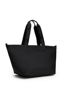 Czarna torba tote wykonana z gładkiego materiału, z podwójnymi uchwytami z logo "TOMMY JEANS", w sztywnym kształcie z otwartym topem.