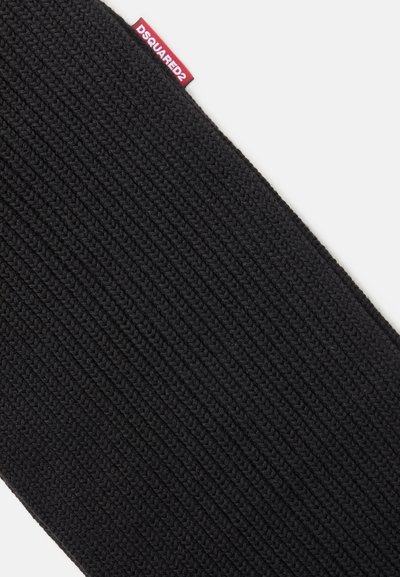Cachecol de malha preta com textura em canelado. Apresenta uma etiqueta de marca DSQUARED2 vermelha. O material parece suave e flexível.