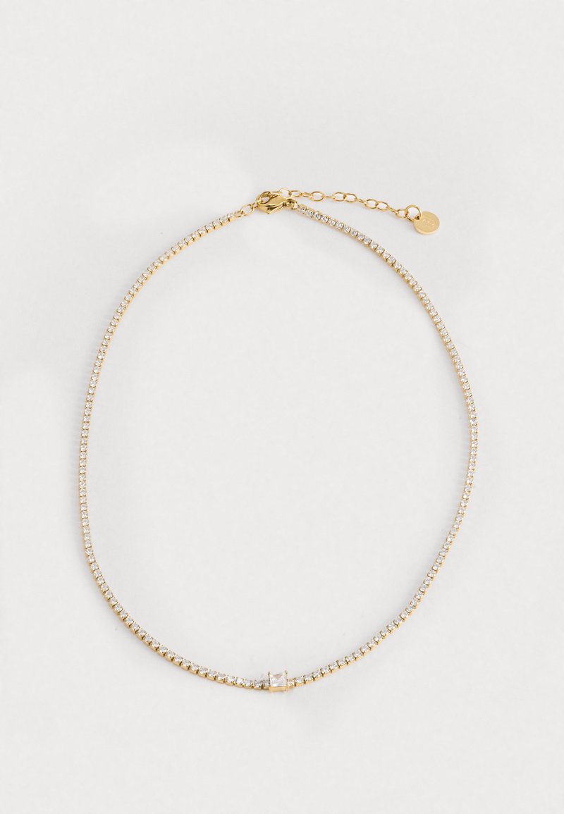 Collana d'oro con piccole pietre in vetro trasparente. Presenta un design a catena delicato, con un gancio a moschettone rotondo e una lunghezza regolabile.