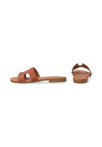 Brown leather sandals with a minimalistic design, featuring a wide strap and a flat sole. Smooth texture and open back detail.