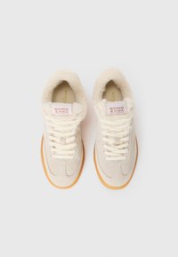 Sneakers in suede beige con colletto in pelliccia crema, lacci crema e suola in gomma color tan. Presentano un logo sulla linguetta.