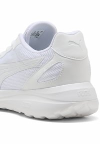 White athletic shoe with mesh upper and synthetic accents. Features padded collar, textured side panel, and branded heel. Soft, lightweight sole.