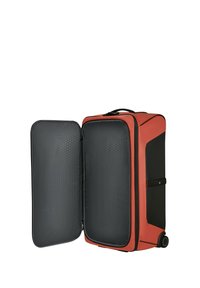 Hard-shell suitcase with a red exterior and black accents, featuring a textured gray interior, dual compartments, and two wheels.