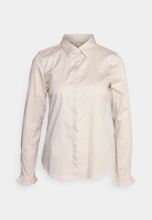 Light beige long-sleeve shirt with a classic collar, button front, and ruffled cuffs. Made of smooth cotton fabric, featuring a tailored fit.