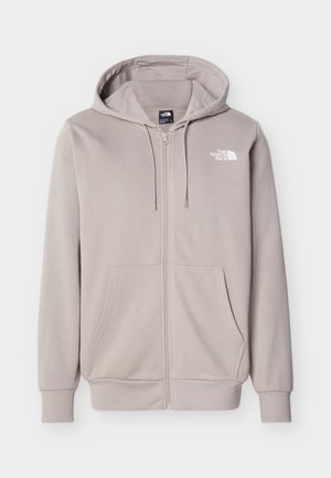 Μπεζ φούτερ με φερμουάρ, κουκούλα, μπροστινές τσέπες, κορδόνια και το λογότυπο της The North Face στο αριστερό στήθος.