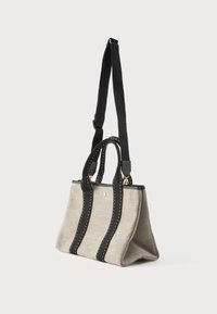 Γκρι τσάντα από ύφασμα με μαύρες δερμάτινες λεπτομέρειες, δύο κοντές λαβές και αποσπώμενο λουρί. Διαθέτει χρυσά αξεσουάρ και αντίθετη ραφή.