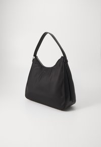 Black nylon shoulder bag with a curved, smooth design. Features a wide opening, a sturdy leather handle, and a subtle sheen.