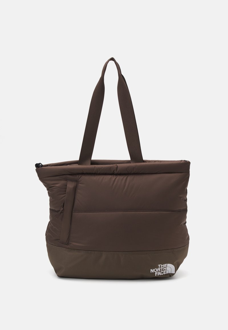 Sac fourre-tout matelassé marron avec double poignée et une poche avant zippée, avec le logo The North Face en bas à droite.